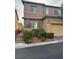 Two-story house with tan exterior, attached garage, and landscaped front yard at 10753 Cather Ave, Las Vegas, NV 89166