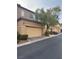 Tan two-story house with attached garage and partial view of neighboring house at 10753 Cather Ave, Las Vegas, NV 89166