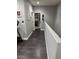 Clean and bright hallway with dark gray flooring and access to other rooms at 10753 Cather Ave, Las Vegas, NV 89166