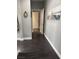 Clean and bright hallway with dark laminate flooring and access to other rooms at 10753 Cather Ave, Las Vegas, NV 89166