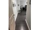 Hallway with dark gray flooring leading to a bedroom at 10753 Cather Ave, Las Vegas, NV 89166