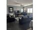 Living room with dark hardwood floors, two sofas, and a piano at 10753 Cather Ave, Las Vegas, NV 89166