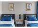 Shared bedroom with two twin beds, blue accents, and modern decor at 175 Enloe St, Henderson, NV 89074