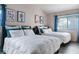 Shared bedroom featuring two beds with modern decor and blue accents at 175 Enloe St, Henderson, NV 89074