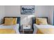 Bedroom with two twin beds, bright yellow accents, and modern decor at 175 Enloe St, Henderson, NV 89074