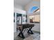 Well-lit game room featuring a foosball table in front of a window, kitchen partially seen in the background at 175 Enloe St, Henderson, NV 89074