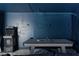 Basement game room with an arcade machine and a ping pong table with blue accent wall at 175 Enloe St, Henderson, NV 89074