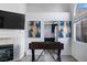 Well-lit game room featuring a foosball table and a partially visible fireplace and kitchen at 175 Enloe St, Henderson, NV 89074