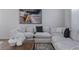 Inviting living room with a sectional sofa, textured rug, and stylish decor at 175 Enloe St, Henderson, NV 89074