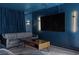 Cozy living room features modern lighting, a large TV, and comfortable gray sofa seating at 175 Enloe St, Henderson, NV 89074