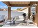 Covered patio with comfortable seating and outdoor grill for delightful gatherings and relaxation at 175 Enloe St, Henderson, NV 89074