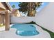 Private pool surrounded by artificial grass and tall block wall that provides an intimate outdoor oasis at 175 Enloe St, Henderson, NV 89074