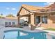 Backyard pool featuring lounge chairs, covered patio, and lush landscaping for outdoor entertaining at 175 Enloe St, Henderson, NV 89074