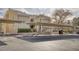 Apartment building with covered parking spaces, neutral stucco facade, and stairs leading to upper units at 1965 Scimitar Dr # 0, Henderson, NV 89014