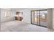 Bright living room featuring a sliding glass door to a balcony and an adjacent kitchen with tiled floor at 1965 Scimitar Dr # 0, Henderson, NV 89014