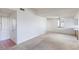 A carpeted living room featuring white walls, a ceiling fan, and natural light from a window at 1965 Scimitar Dr # 0, Henderson, NV 89014