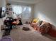 Bright bedroom with orange couch and workspace at 2609 Via Napoli, Henderson, NV 89044