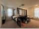 Spacious bedroom with canopy bed, large windows, and carpeted floor at 2609 Via Napoli, Henderson, NV 89044