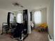 Main bedroom with canopy bed and a yellow accent chair at 2609 Via Napoli, Henderson, NV 89044