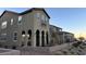 Two-story townhome with stucco exterior, balcony, and arched entryway at 2609 Via Napoli, Henderson, NV 89044