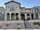 Two-story townhome with stucco exterior, balcony, and arched entryway at 2609 Via Napoli, Henderson, NV 89044