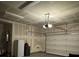 Unfinished garage with garage door opener and mini-fridge at 2609 Via Napoli, Henderson, NV 89044