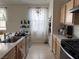 Modern kitchen with light wood cabinets, stainless steel appliances and a large island at 2609 Via Napoli, Henderson, NV 89044