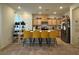 Modern kitchen with island and four yellow barstools at 2609 Via Napoli, Henderson, NV 89044