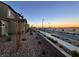 Residential street view with desert landscaping and sunset at 2609 Via Napoli, Henderson, NV 89044