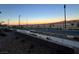 View of a residential street with desert landscaping at sunset at 2609 Via Napoli, Henderson, NV 89044