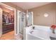 Bathroom features a shower, tub, and walk-in closet at 2925 Wigwam Pkwy # 2021, Henderson, NV 89074