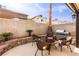 Relaxing backyard with outdoor kitchen, chairs, and fire pit, perfect for entertaining at 8737 Autumn Valley Ave, Las Vegas, NV 89129