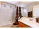 Bright bathroom with tiled shower, vanity, and large mirror at 8737 Autumn Valley Ave, Las Vegas, NV 89129