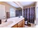 Bathroom with double vanity, decorative shower curtain, and natural light at 8737 Autumn Valley Ave, Las Vegas, NV 89129