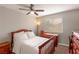 Guest bedroom featuring a ceiling fan, carpeted floors, and a window with blinds at 8737 Autumn Valley Ave, Las Vegas, NV 89129