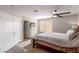 Cozy bedroom featuring a ceiling fan, carpeted floors, and ensuite bathroom at 8737 Autumn Valley Ave, Las Vegas, NV 89129