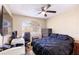 Spare bedroom with dark bedding, ceiling fan, desk, and TV at 8737 Autumn Valley Ave, Las Vegas, NV 89129