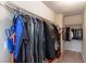 Walk-in closet with organized hanging storage and built-in shelving at 8737 Autumn Valley Ave, Las Vegas, NV 89129