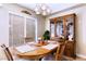 Cozy dining room with wooden table, seating for four, and large china cabinet at 8737 Autumn Valley Ave, Las Vegas, NV 89129