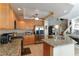 Modern kitchen featuring stainless steel appliances, granite countertops, tile floors, and breakfast bar at 8737 Autumn Valley Ave, Las Vegas, NV 89129