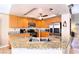 Modern kitchen with granite countertops, a stainless steel appliance suite, tile flooring and an island at 8737 Autumn Valley Ave, Las Vegas, NV 89129