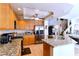 Bright kitchen featuring granite countertops, stainless appliances, tile floor and an island with a sink at 8737 Autumn Valley Ave, Las Vegas, NV 89129