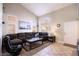 Bright living room featuring tile floors, high ceilings, large windows, and comfortable seating area at 8737 Autumn Valley Ave, Las Vegas, NV 89129