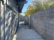 Side yard with block wall and metal gate, offering a sense of privacy and security at 1812 Ryan Ave, Las Vegas, NV 89101