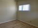 Small bedroom with wood flooring and a window with blinds at 1812 Ryan Ave, Las Vegas, NV 89101
