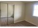 Bedroom featuring wood flooring, a window, and mirrored closet doors at 1812 Ryan Ave, Las Vegas, NV 89101