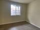 Bedroom featuring wood flooring, a window, and an electrical outlet at 1812 Ryan Ave, Las Vegas, NV 89101