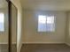 Bedroom with wood flooring, window, and closet with mirror doors at 1812 Ryan Ave, Las Vegas, NV 89101