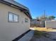 Side yard with partial view of home's exterior and block wall fence at 1812 Ryan Ave, Las Vegas, NV 89101