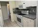 Updated kitchen with white cabinets, gray countertops and stainless steel appliances at 1812 Ryan Ave, Las Vegas, NV 89101